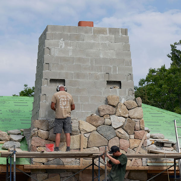 Custom Exterior Granite Fireplace and Chimney Being Crafted in Bar Harbor